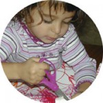 Young girl using sissors