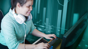 A blind woman with headphones who is typing on a braille keyboard. An artistic bar graph is overlayed in the teal background.